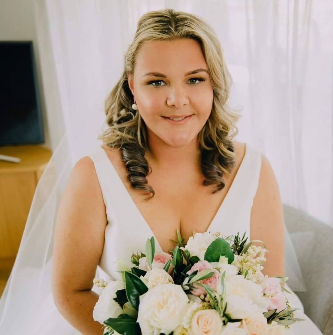Bride with soft curls and natural glam makeup by Beauty Hustle