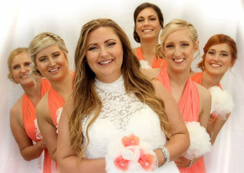Bride and bridesmaids with coordinated hair and makeup