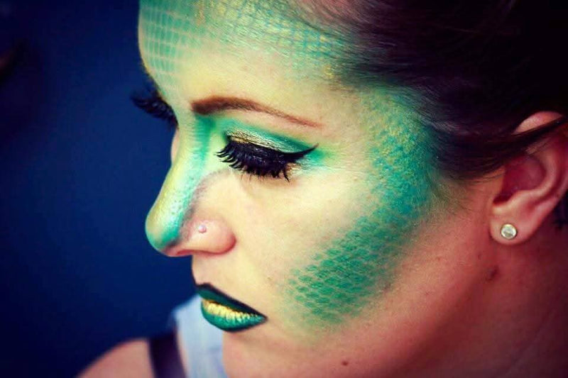 Creative special effects makeup with green scales