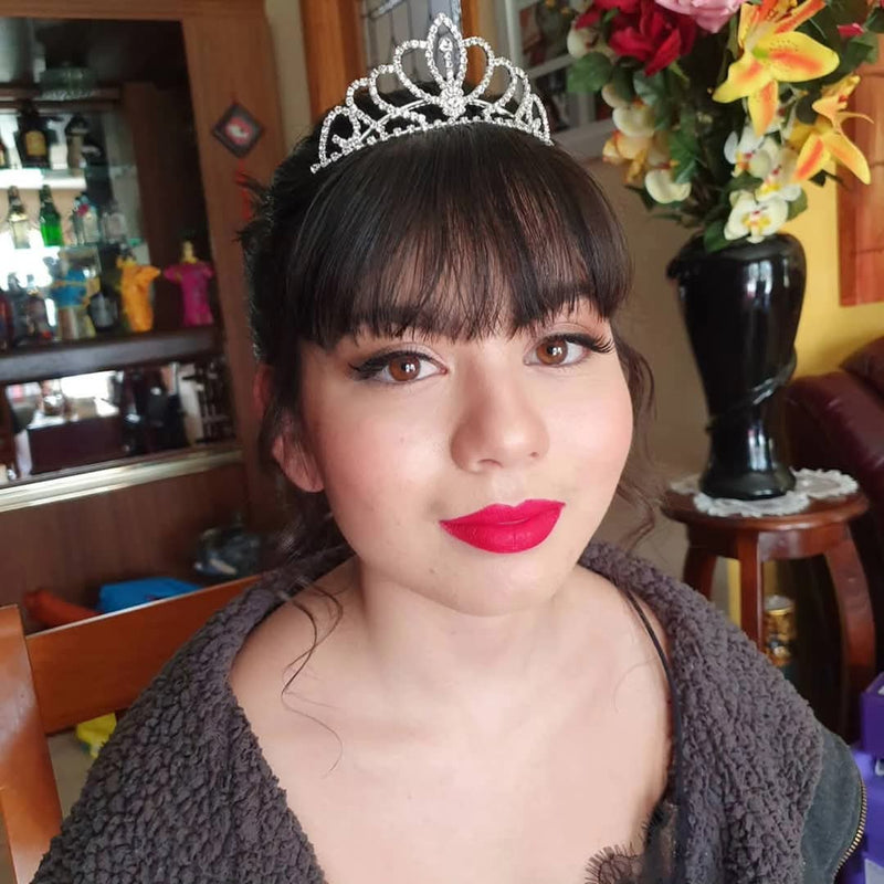 Glam makeup with bold red lip and tiara